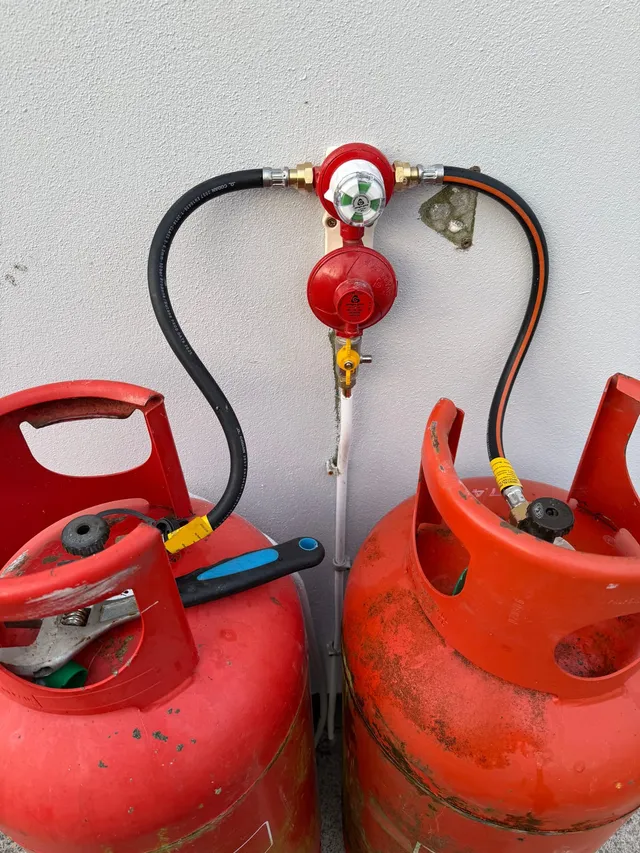 A pair of Calor gas cylinders with an automatic changeover regulator